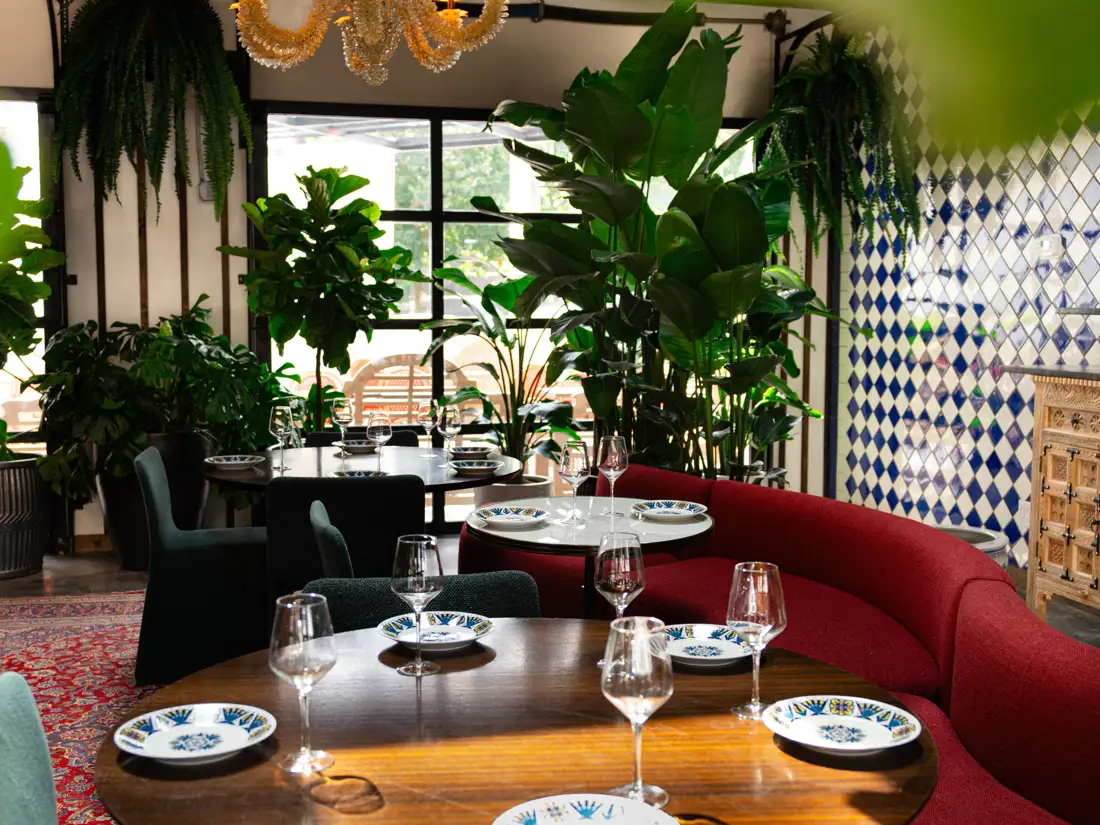 Interior of dining room with tables and booths at Beatnik Lincoln Park in Chicago. 